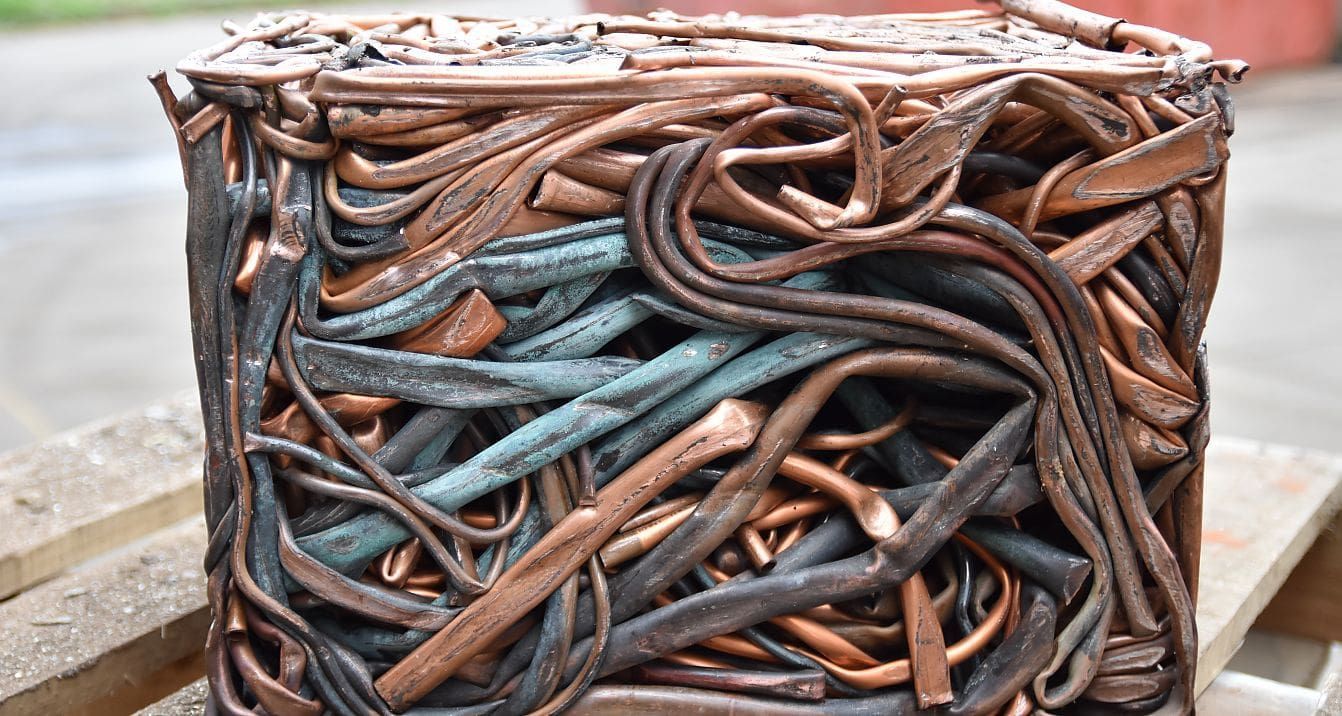 A Close Up of a Sculpture Made of Copper Wires Sitting on Top of a Wooden Pallet — Newport Recycling in Woree, QLD