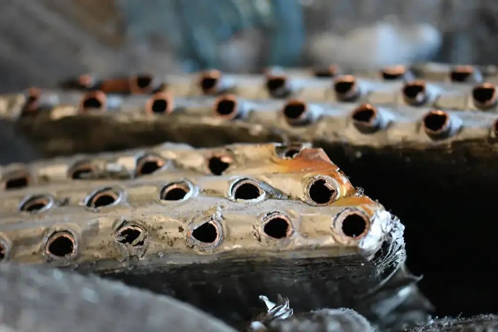 A Close Up of a Piece of Metal With Holes in It — Newport Recycling in Woree, QLD
