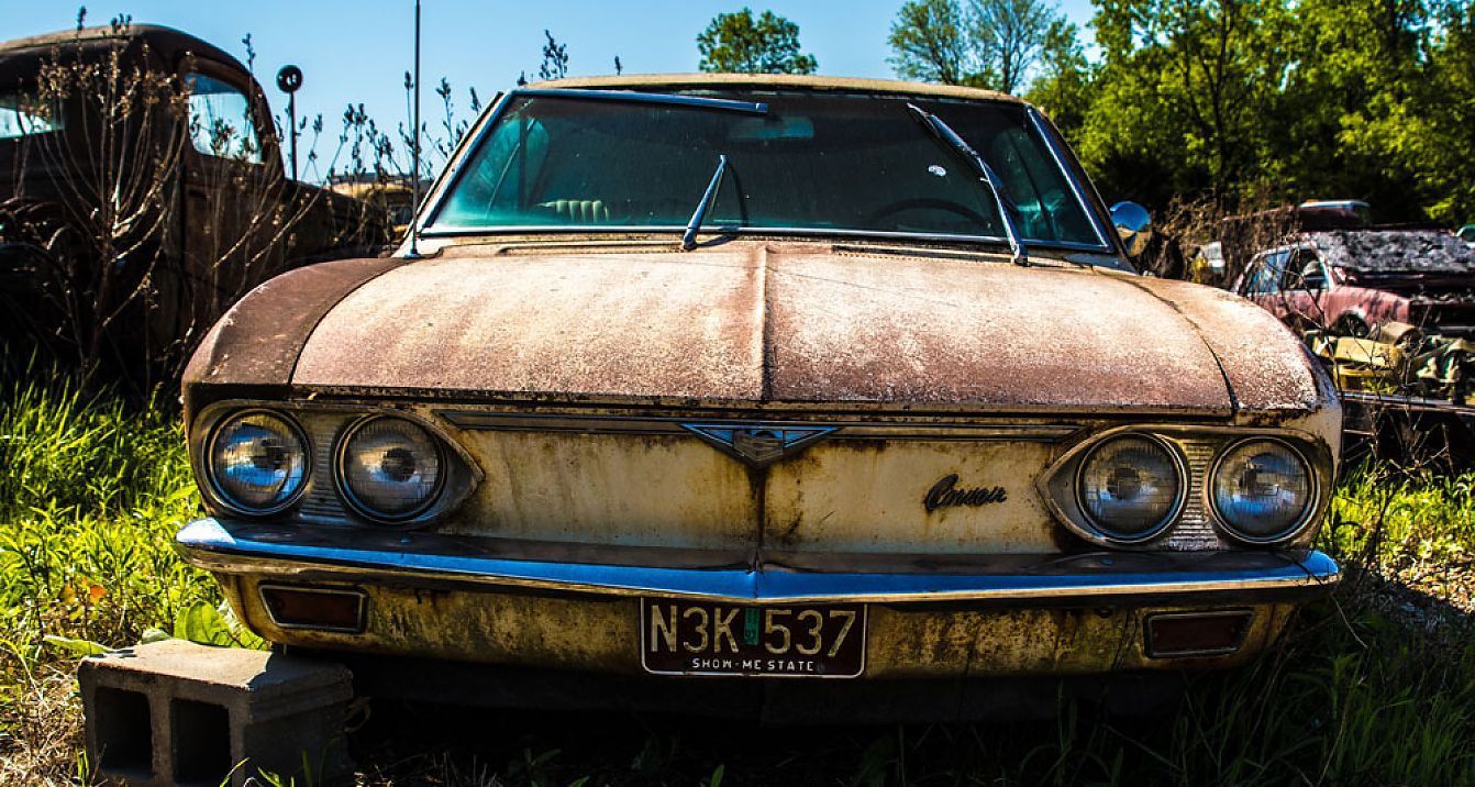 An Old Rusty Car With a License Plate That Says N3k 537 is Parked in the Grass — Newport Recycling in Woree, QLD