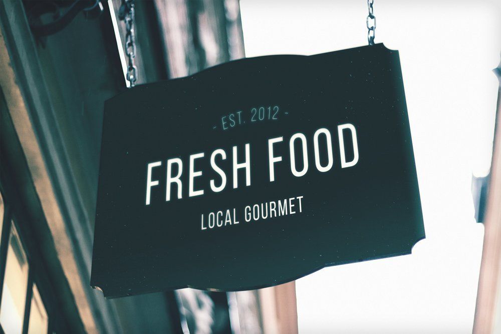 A sign that says fresh food local gourmet on it
