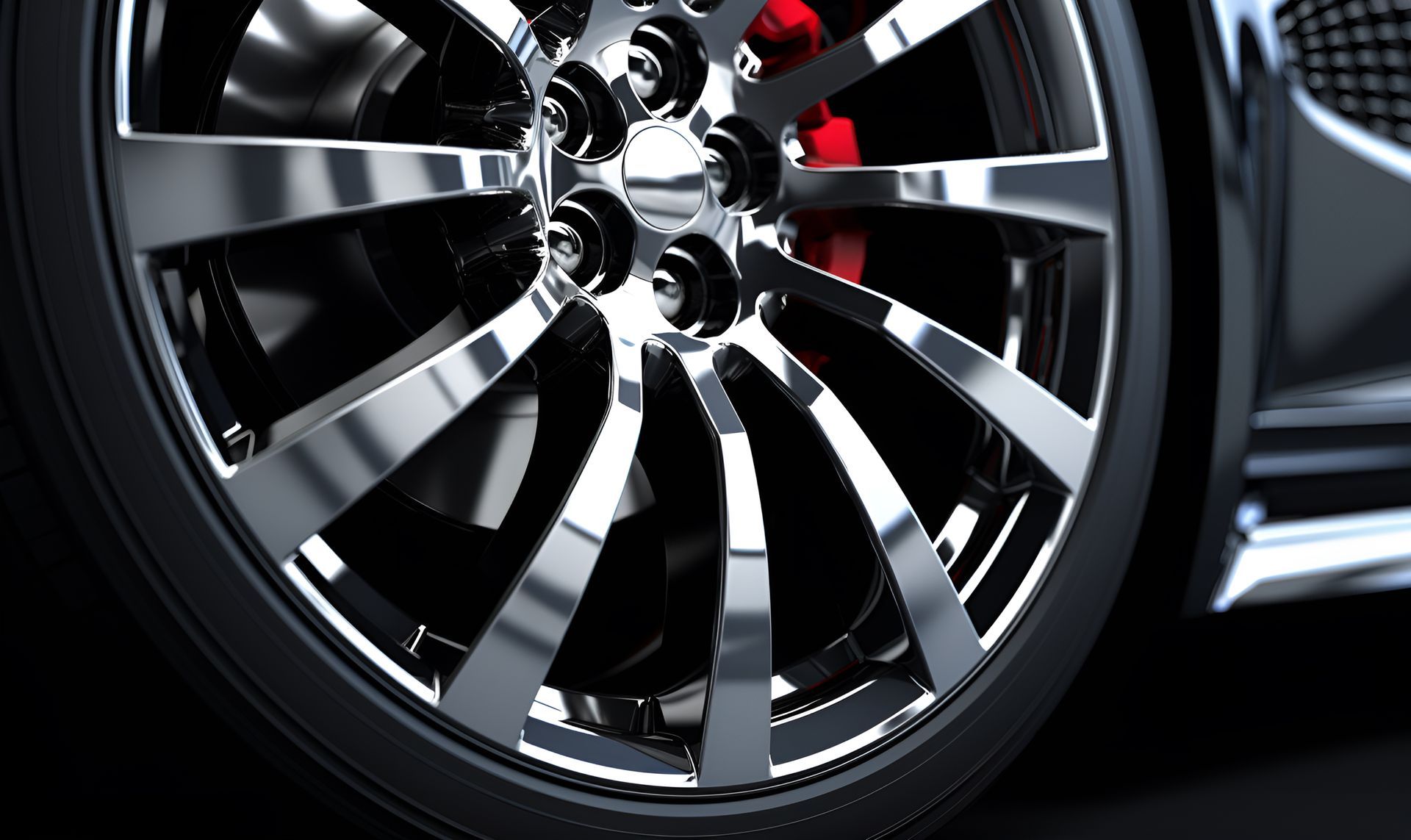 A close up of a car wheel with a red brake caliper.