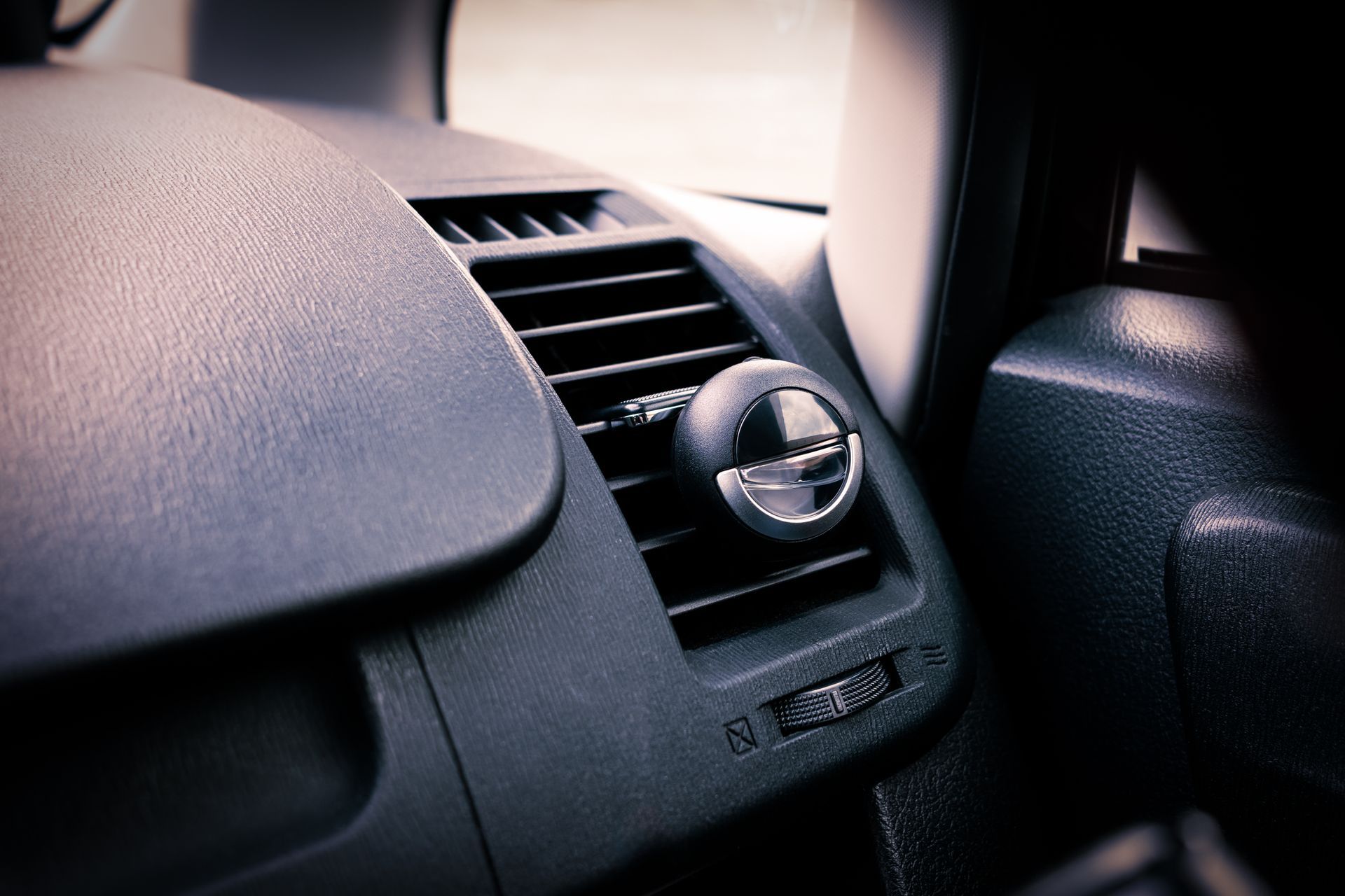 A close up of an air vent in a car