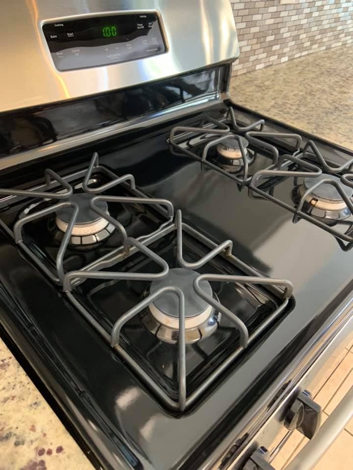 Interior view of a disassembled dryer with a blower housing and motor visible on a metal base, resting on grass.