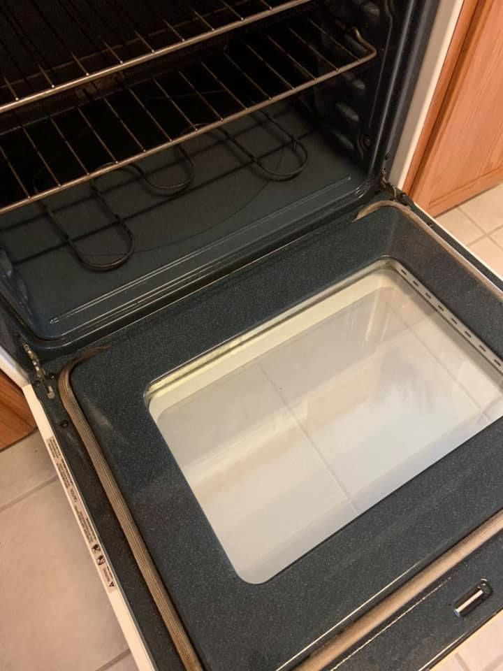 Open oven with interior shelf and glass window in the door