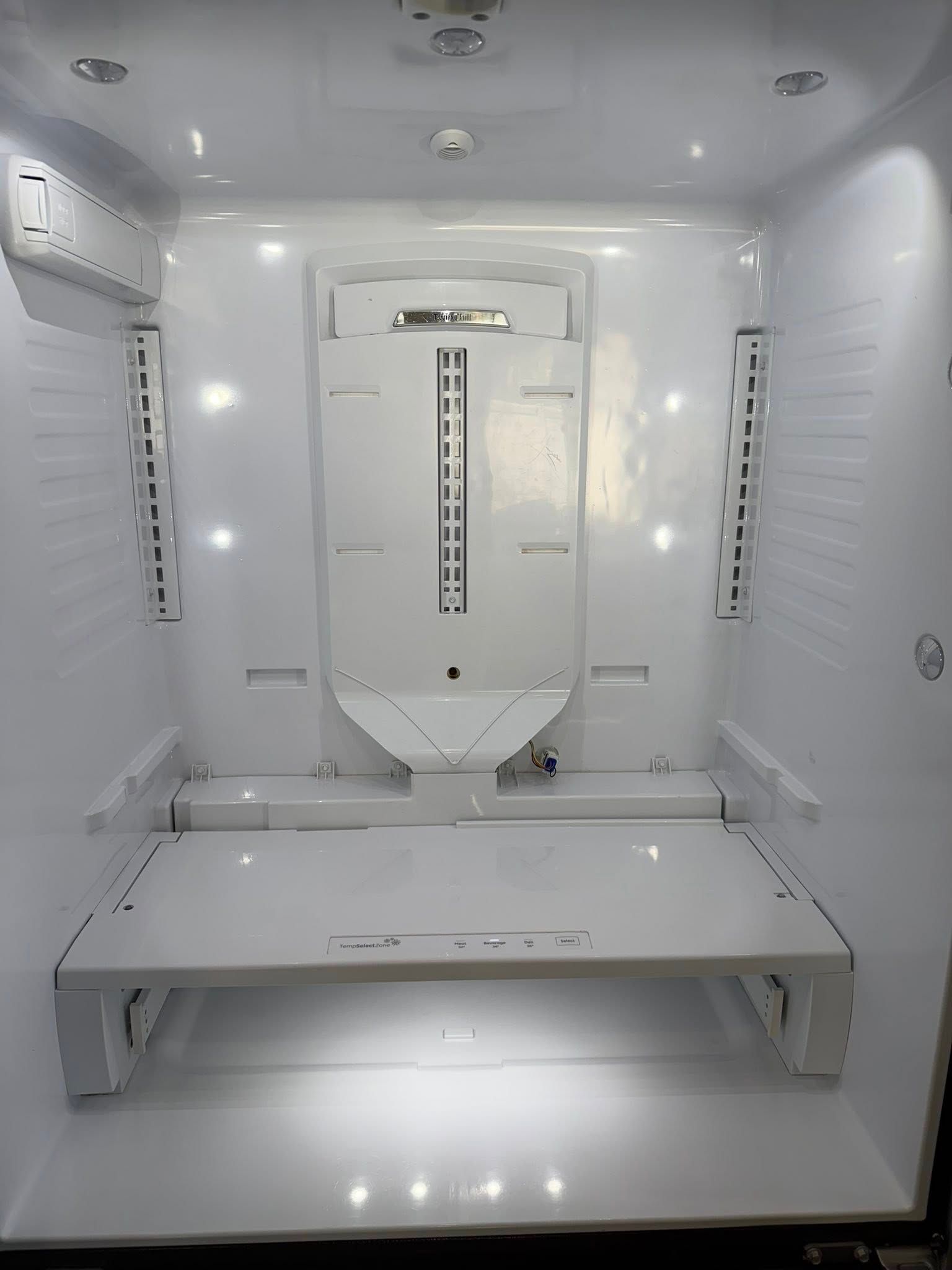 White sterilization chamber with shelves, vents, and a central panel inside a clean enclosed room