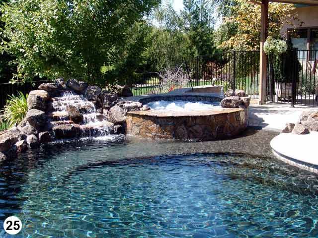 There is a waterfall in the middle of the pool.