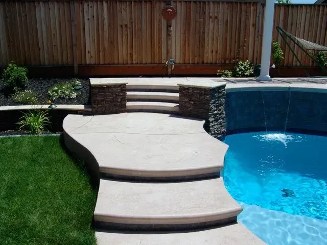 A swimming pool with stairs leading up to it