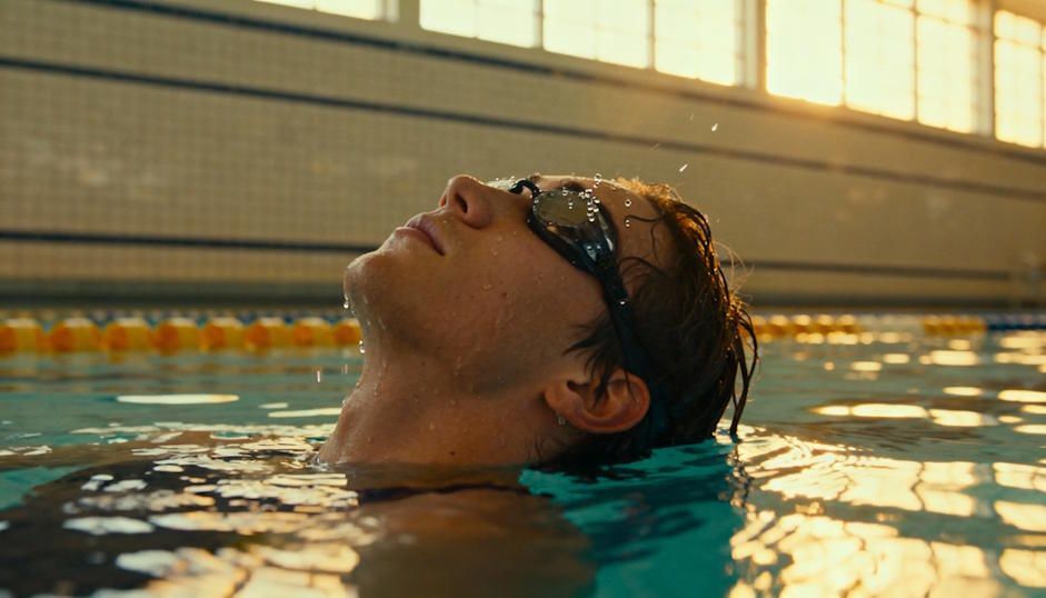 A swimmer visualizing success at a Chesapeake indoor pool, shimmering water reflections