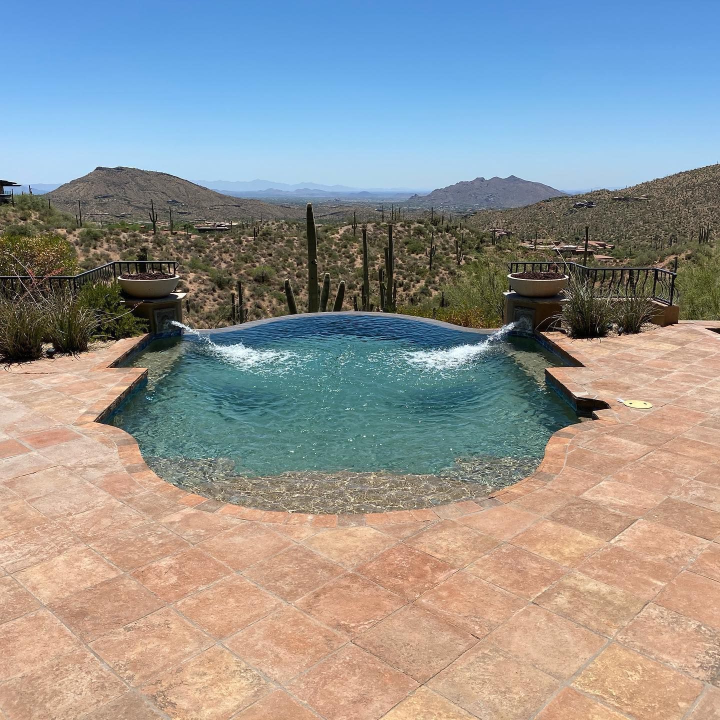 A large swimming pool with a view of the desert