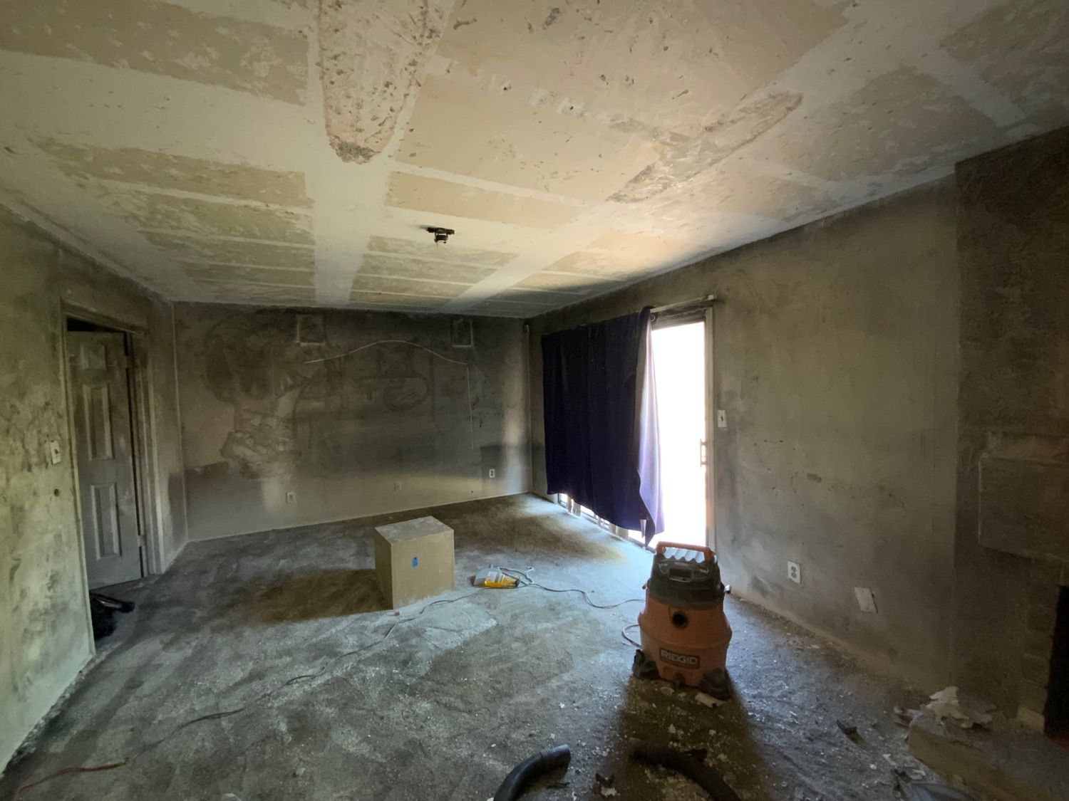 There is a vacuum cleaner in the middle of the room.