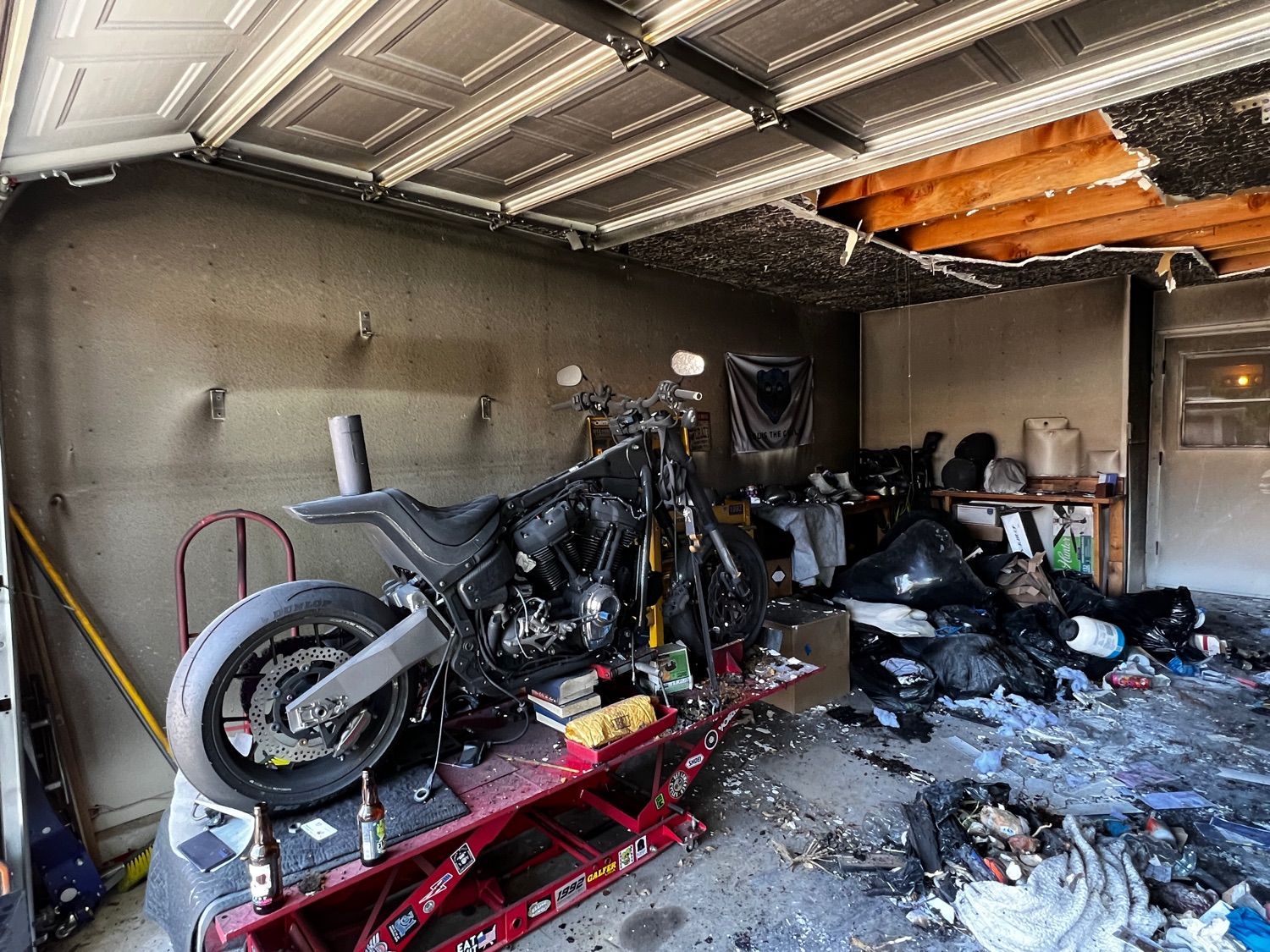 A motorcycle is sitting on a lift in a garage.