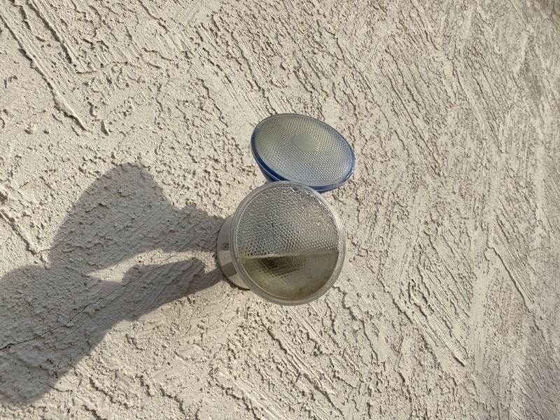 A close up of a light fixture on a wall.