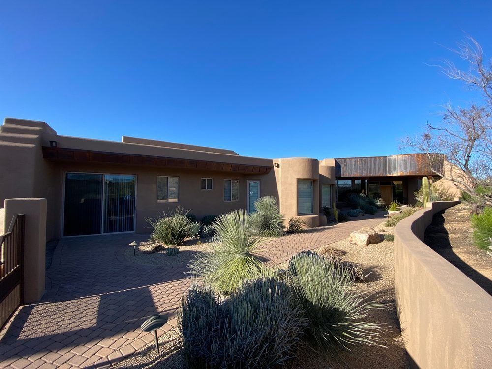 A large house with a brick walkway leading to it