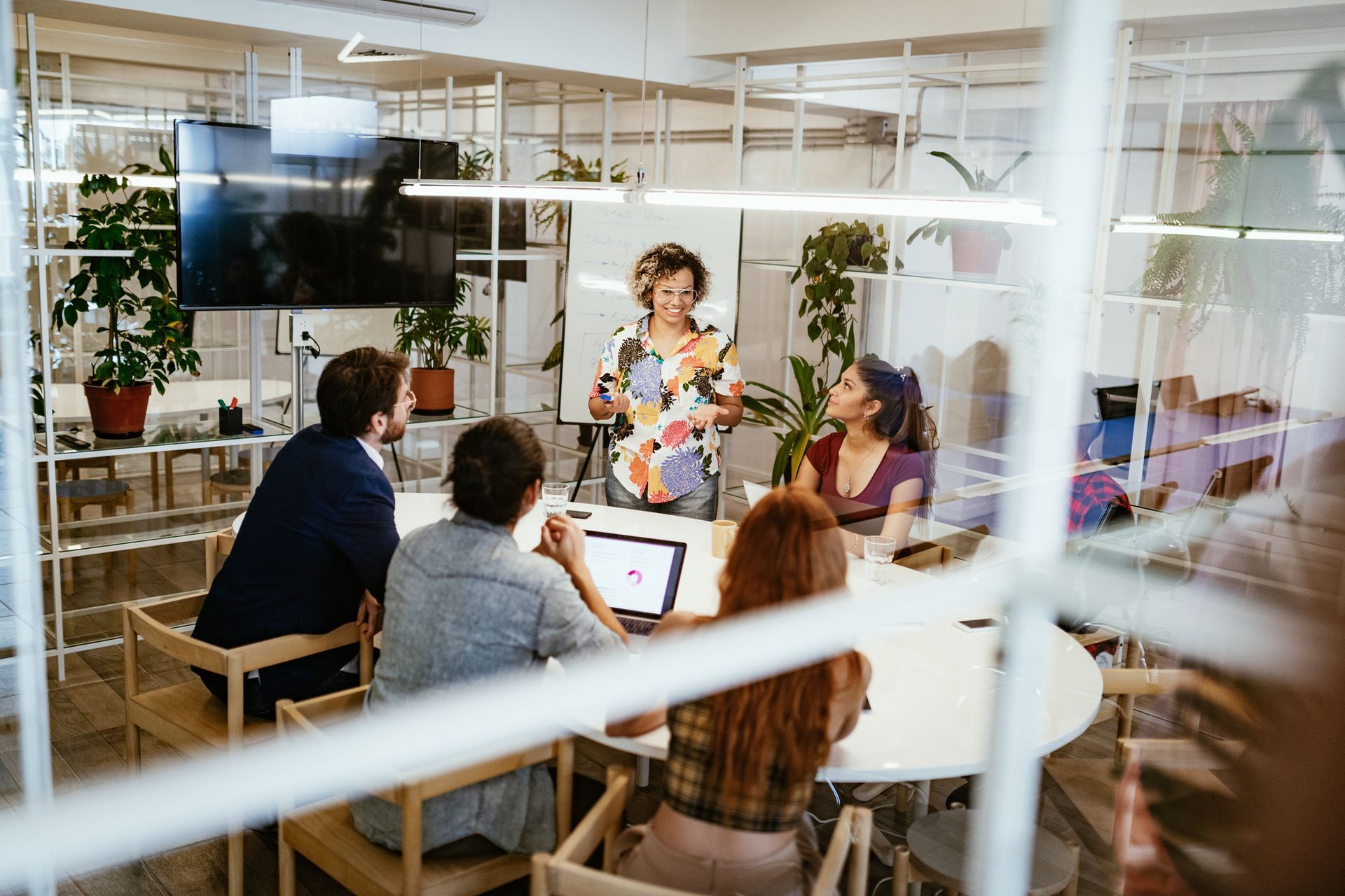 A group of people are sitting around a table in a conference room.
