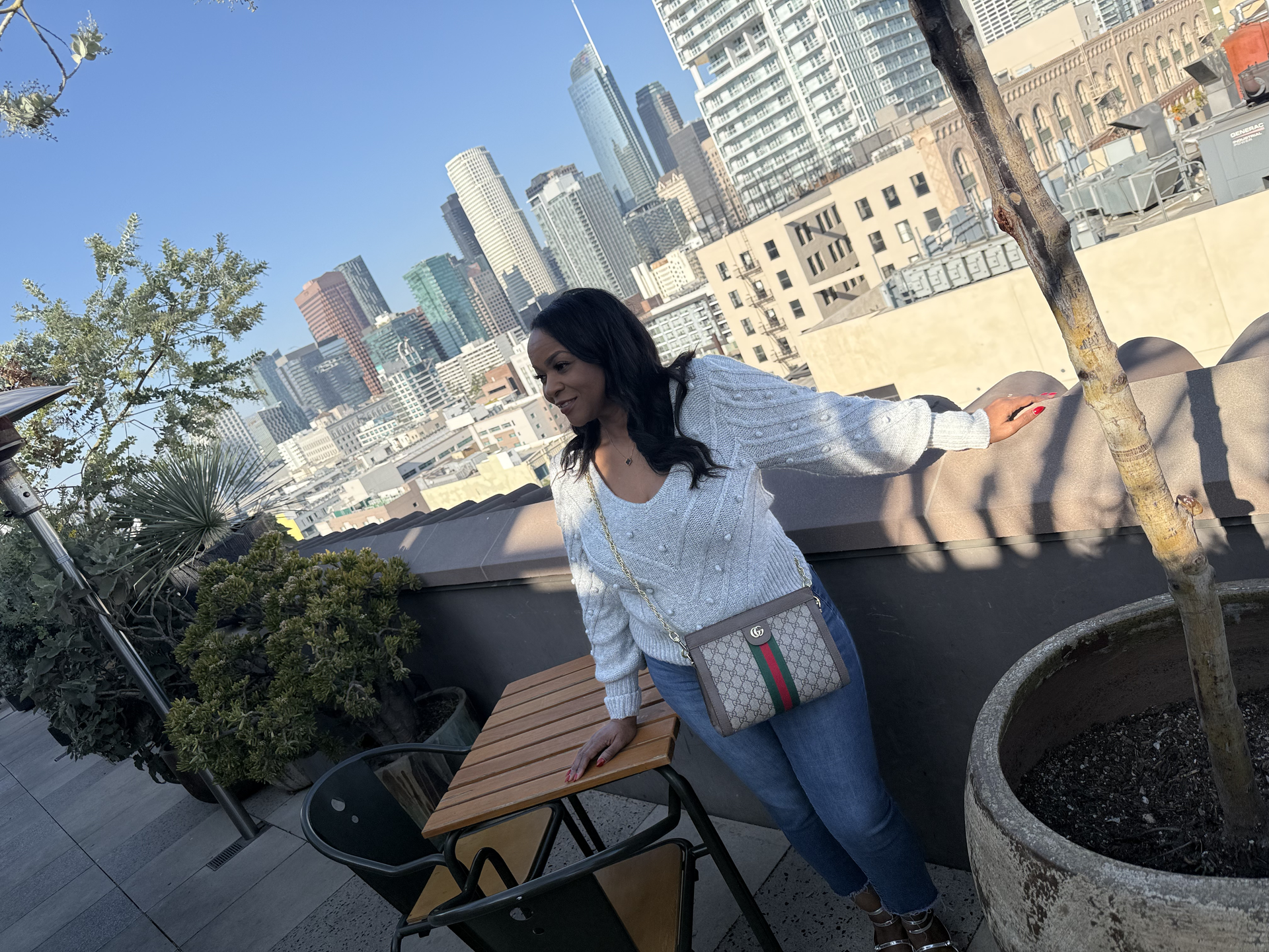 A woman is sitting at a table with a tablet and a pen in her hand.