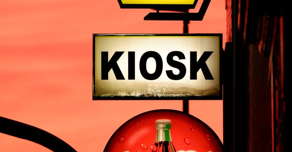 A kiosk sign with a coca cola bottle on it
