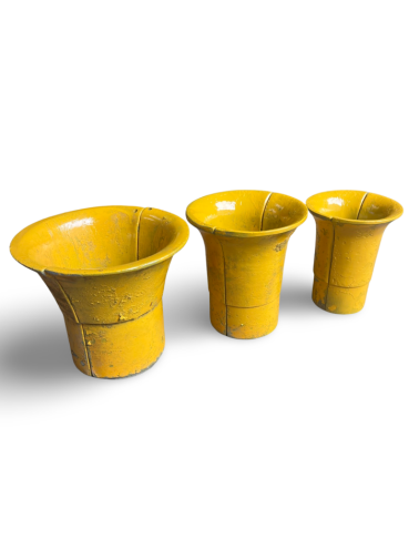 Three yellow cups are lined up in a row on a white background.