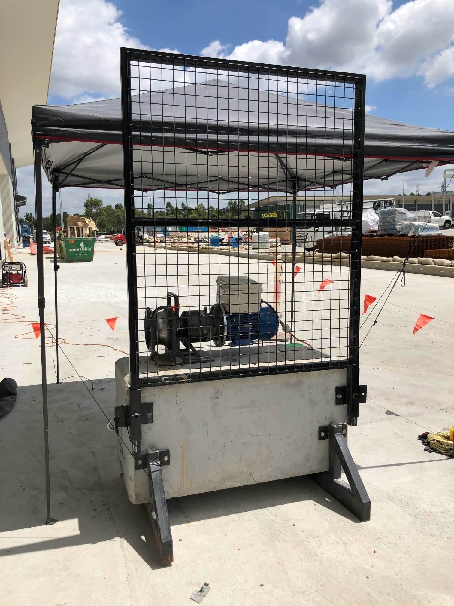 A cage with a canopy on top of it in a parking lot