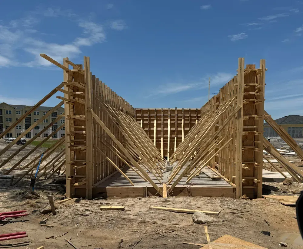 A building under construction with a blue sky in the background