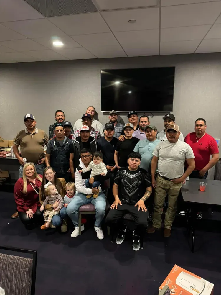 A group of people are posing for a picture in a room.