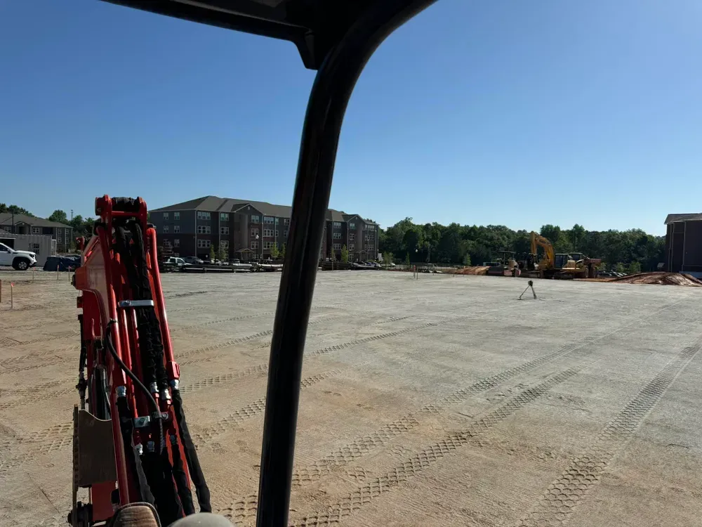 A person is driving a bulldozer on a construction site.