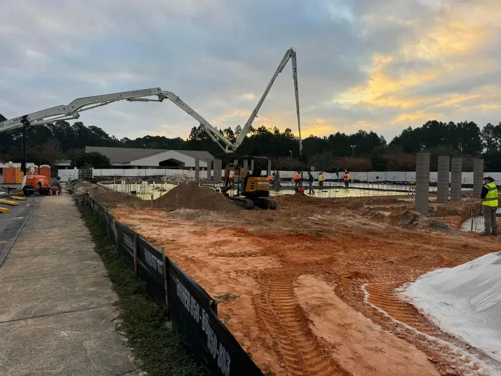 A concrete pump is being used to pour concrete on a construction site.