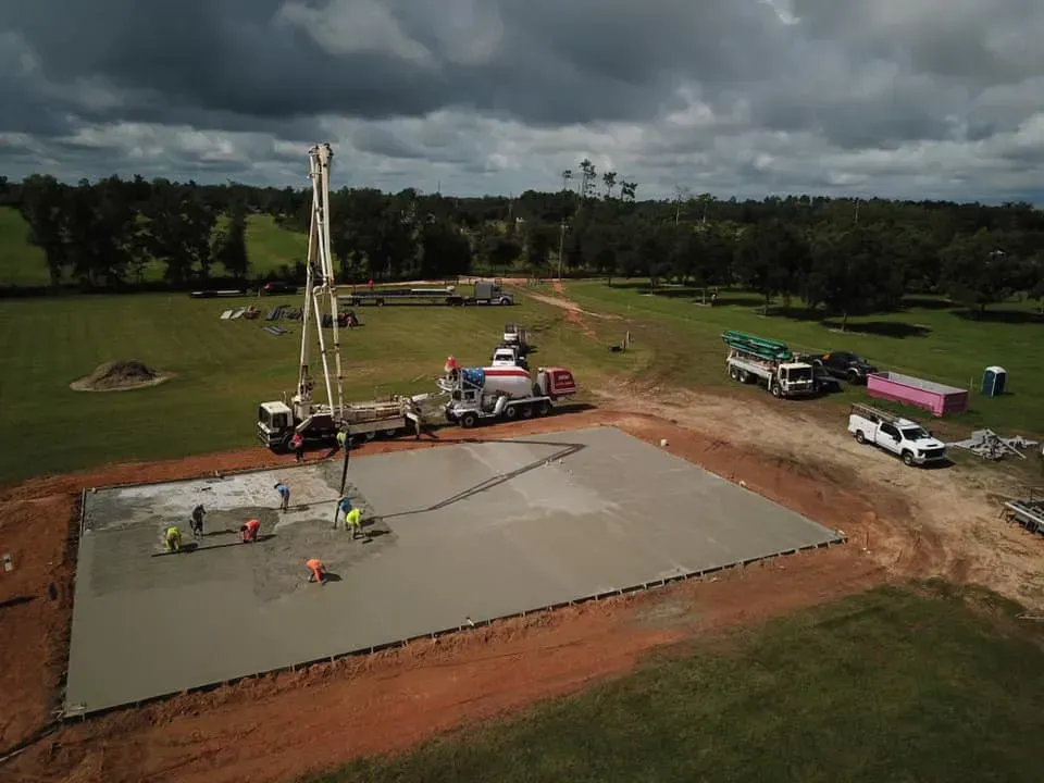 An aerial view of a construction site with a concrete pump.