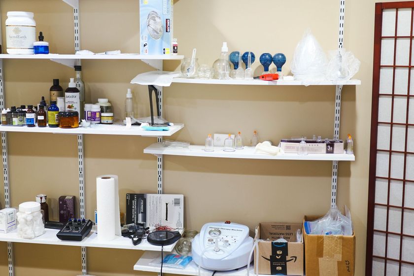 A room with shelves filled with various items including a machine