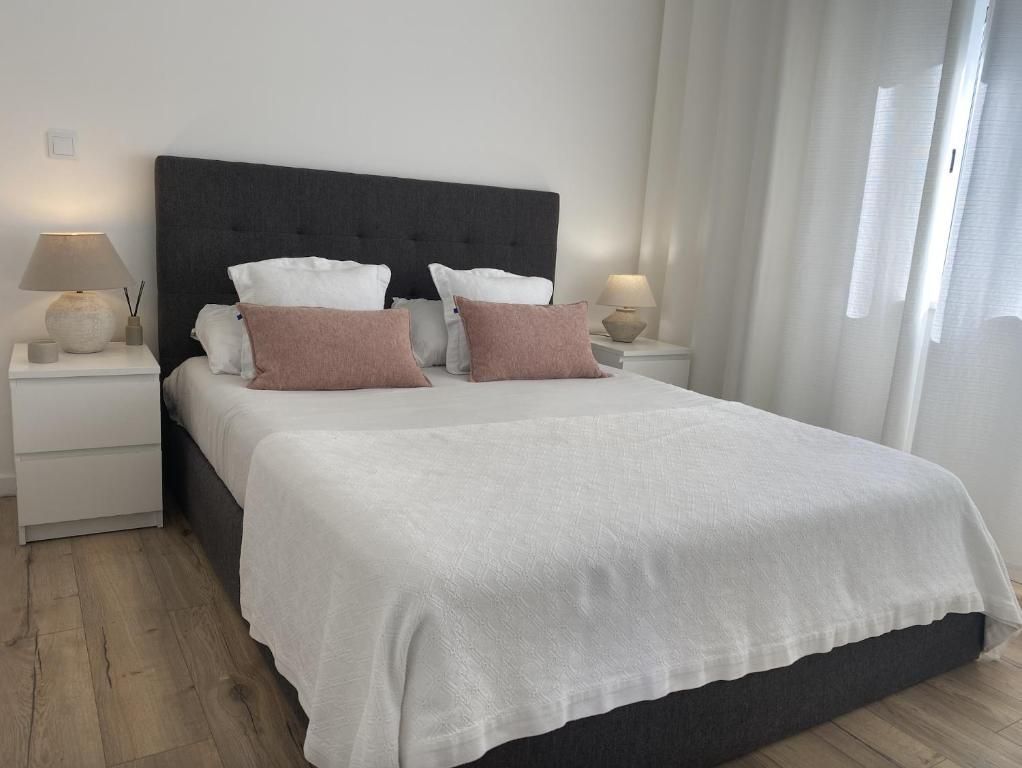 A bedroom with a large bed and two bedside tables