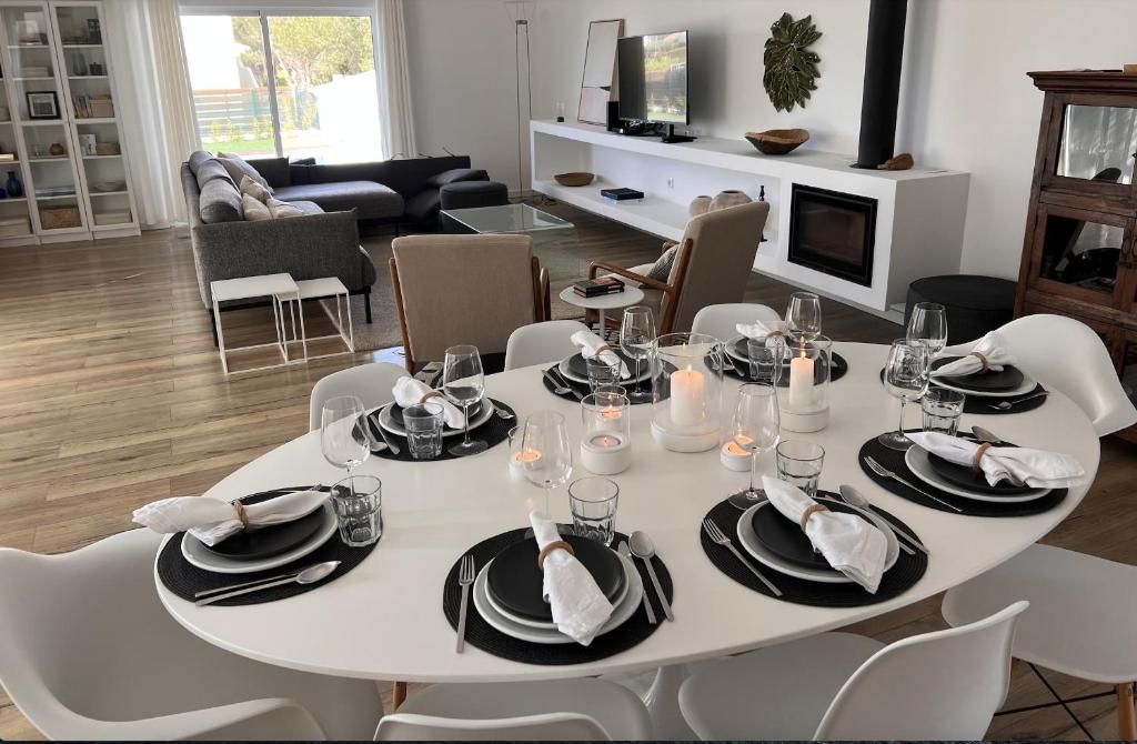 A dining table with plates and glasses