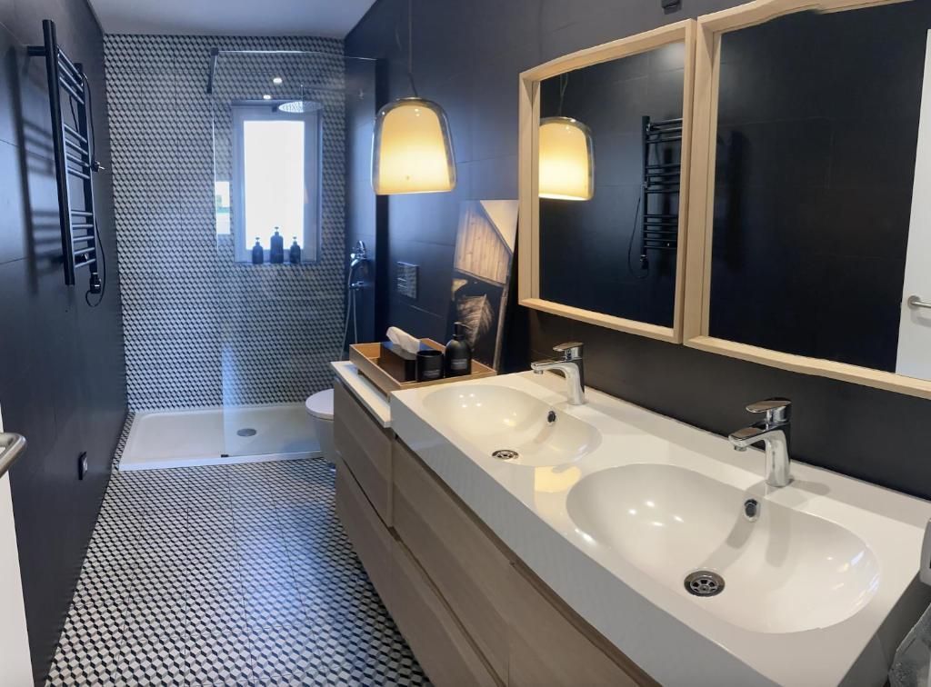 A bathroom with two sinks and two mirrors