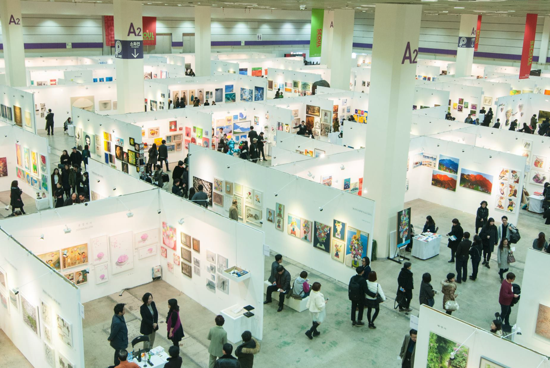 an aerial view of a large art gallery filled with people .