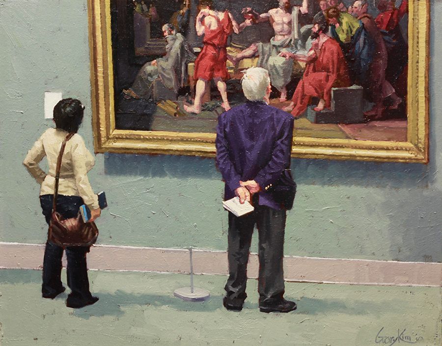Two people are looking at a painting in a museum
