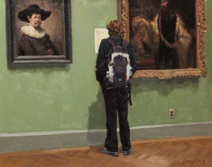 A person with a backpack is looking at a painting in a museum.