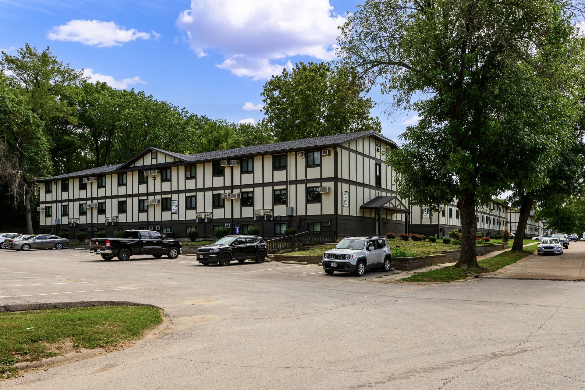 A building with a lot of cars parked in front of it