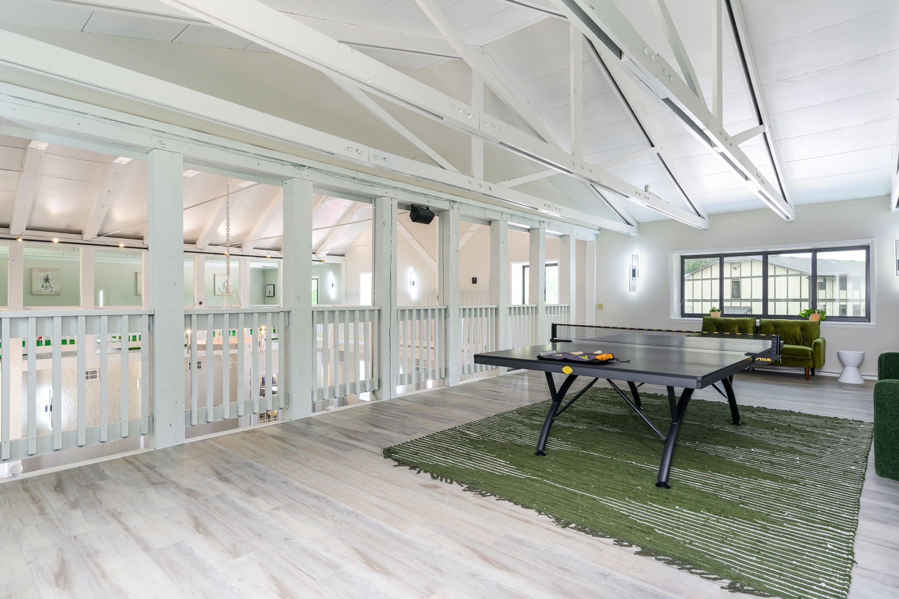 There is a ping pong table in the middle of the room.