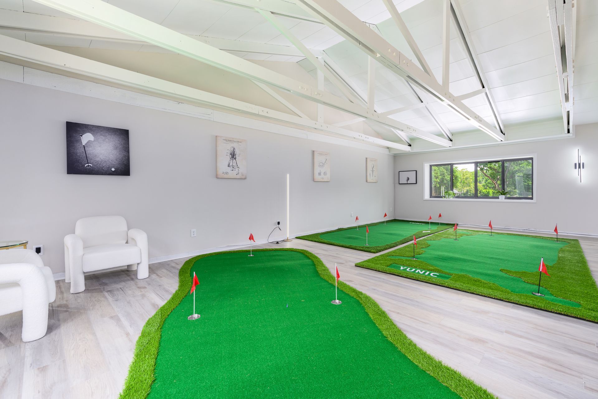 There is a putting green in the middle of the room.