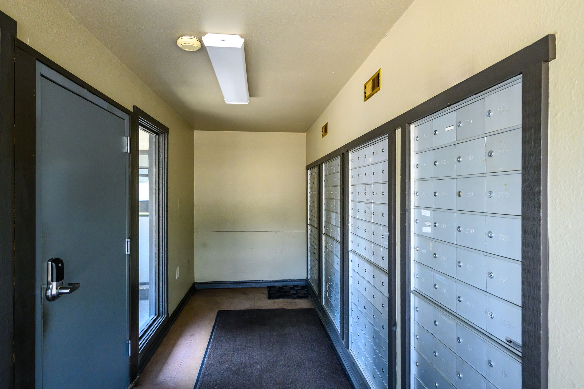 A hallway with a lot of mailboxes in it