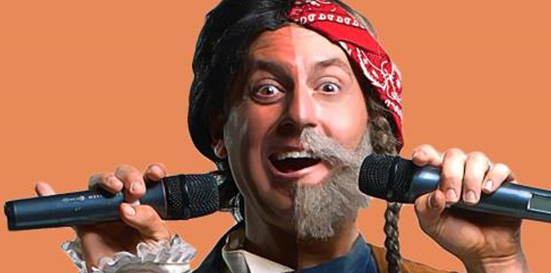 A man with a beard is singing into two microphones.