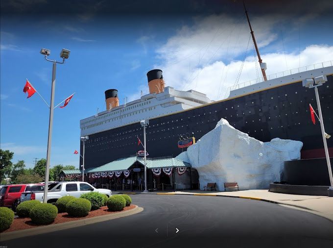 A large cruise ship with a large iceberg in front of it