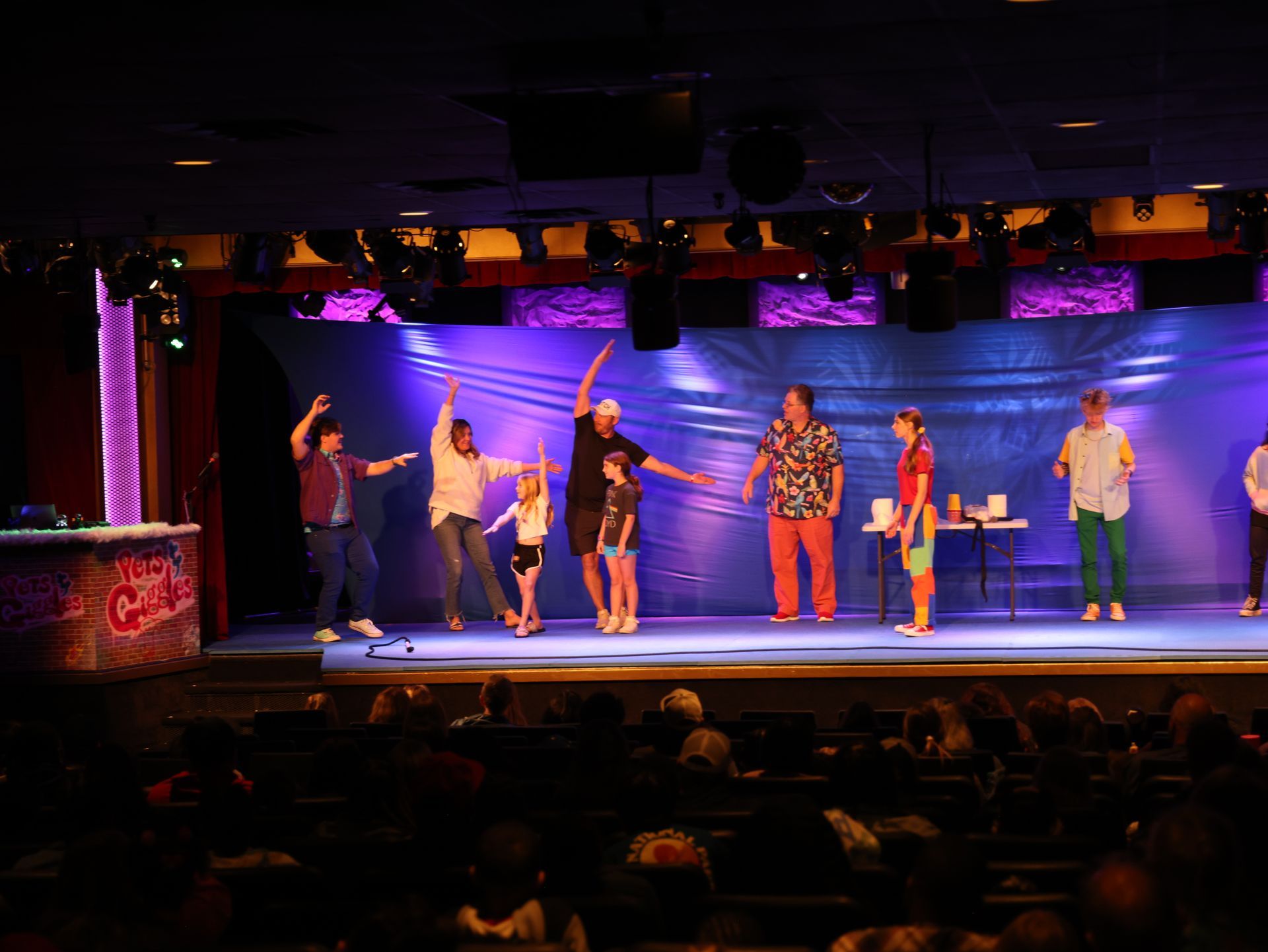 A group of people are standing on a stage in front of a crowd.