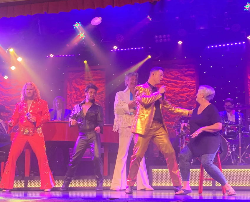 A group of people are dancing on a stage.