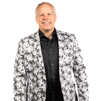 A man wearing a black shirt and a white floral jacket