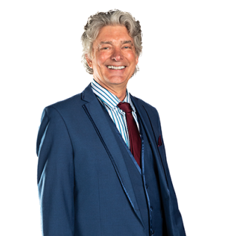 A man in a suit and tie is smiling for the camera.