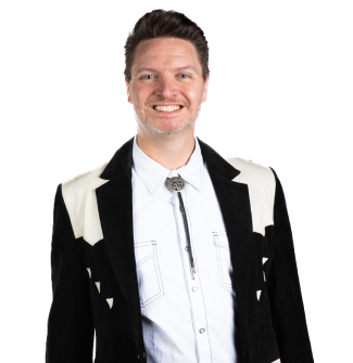 A man wearing a black and white jacket and a white shirt