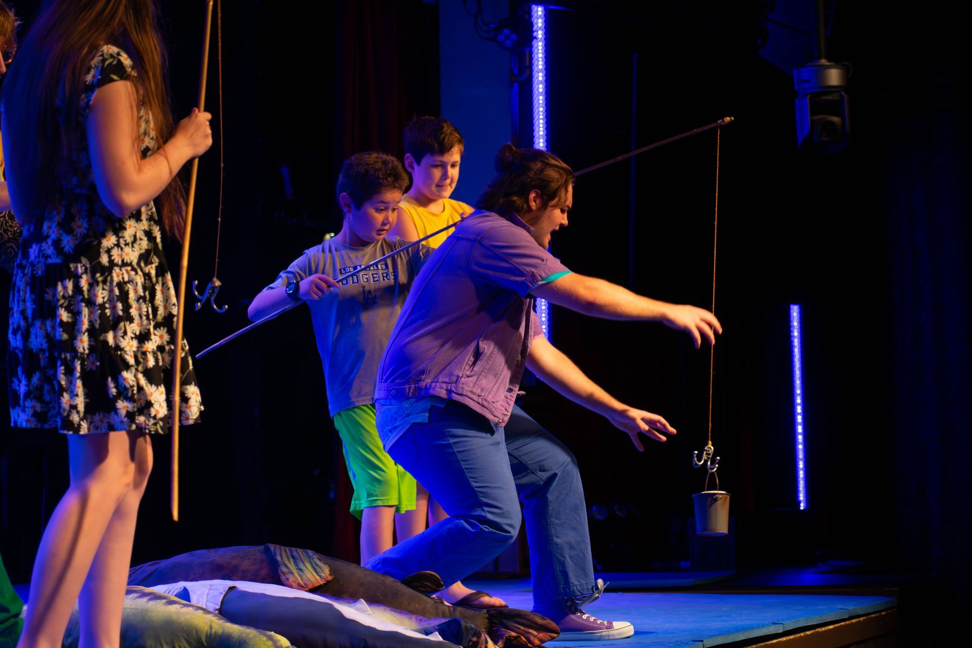 A group of children are playing a game on a stage.