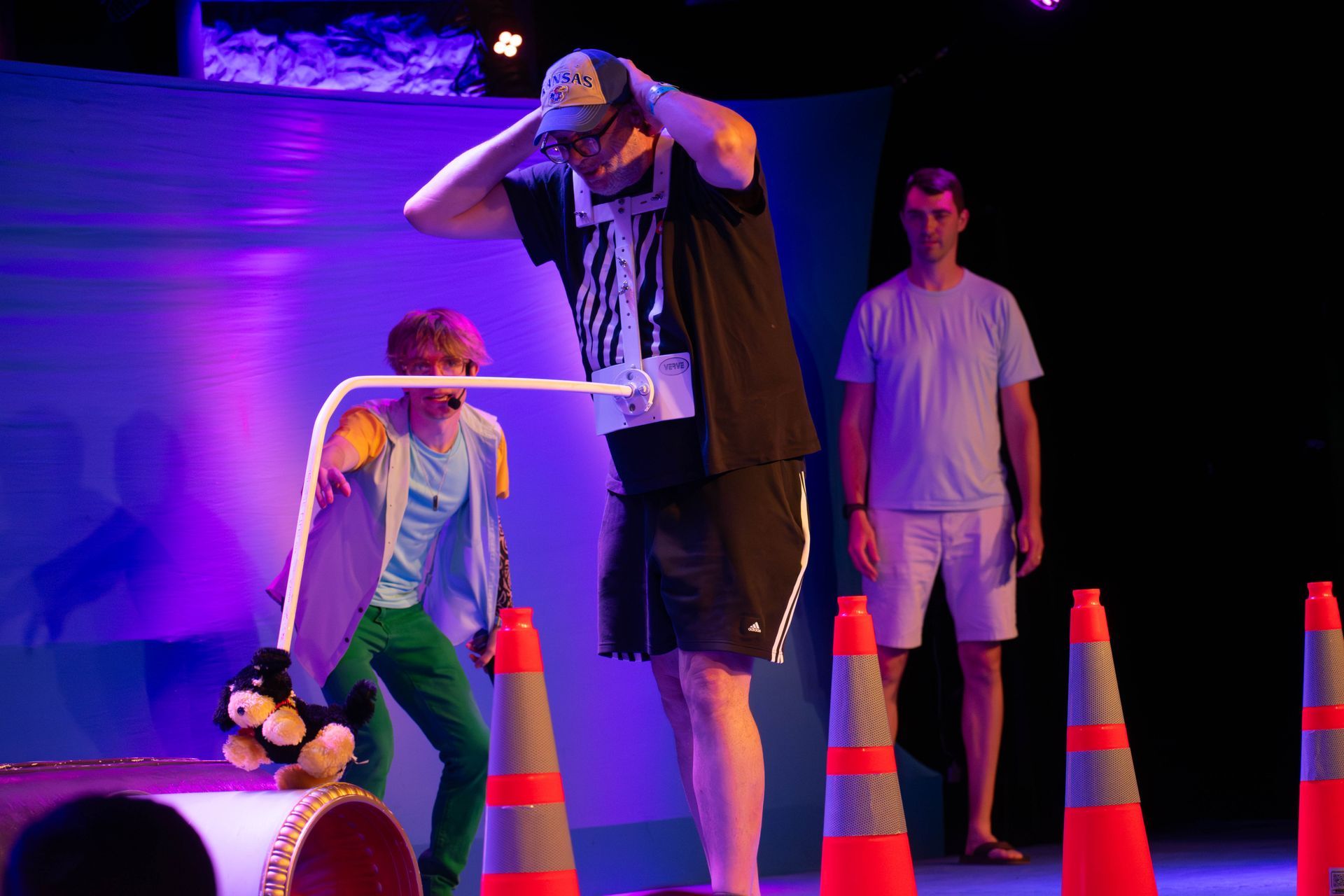 A man and a boy are playing a game with traffic cones