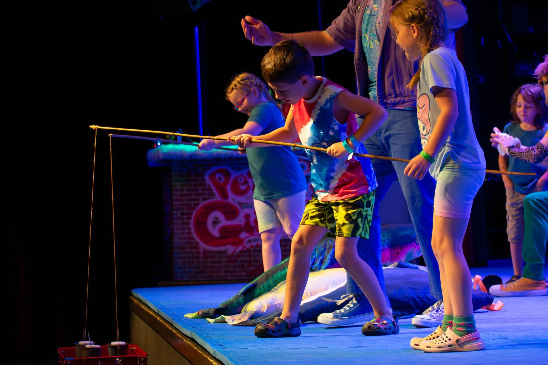 A group of children are playing a game on a stage.