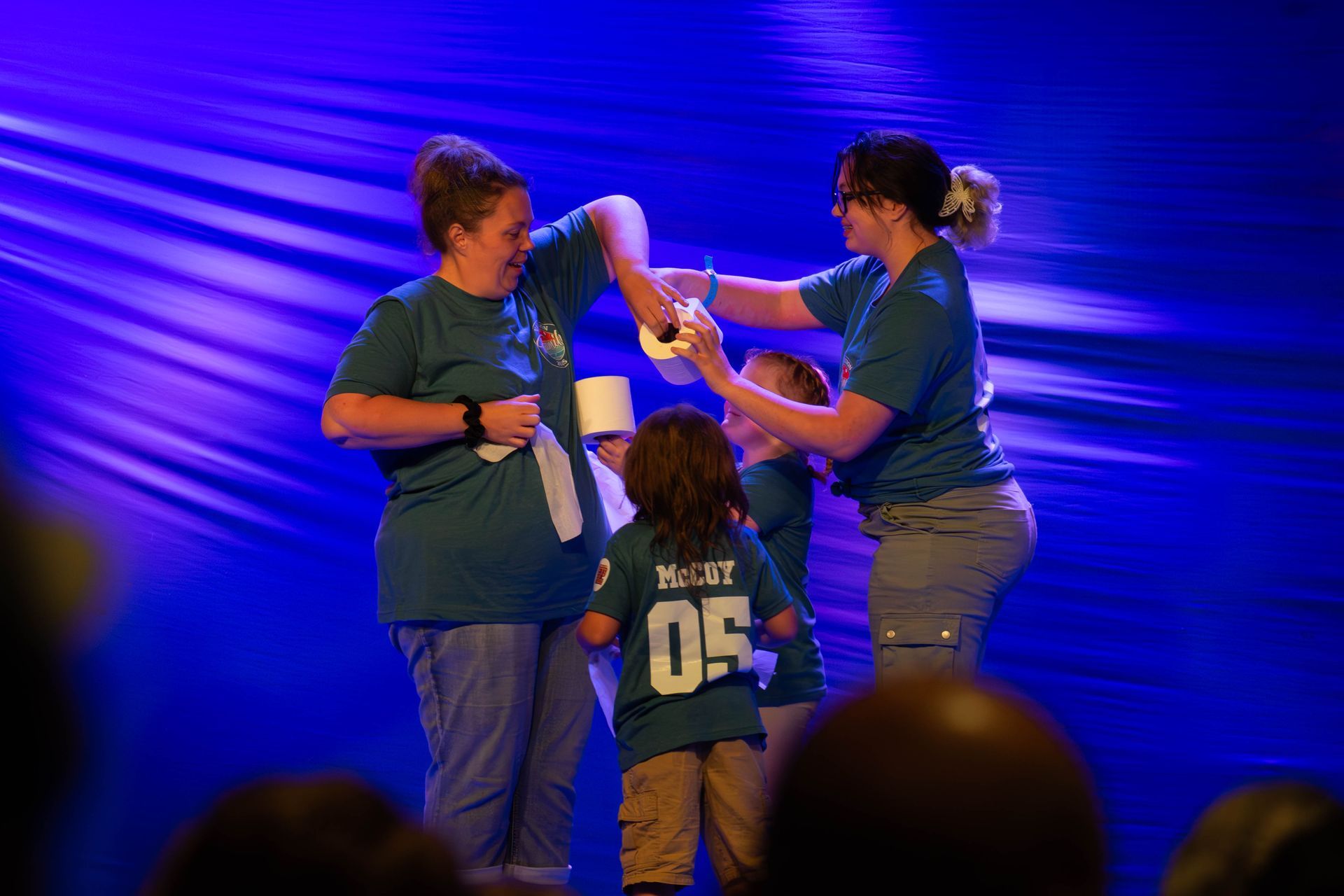 A group of people wearing green shirts with the number 05 on them