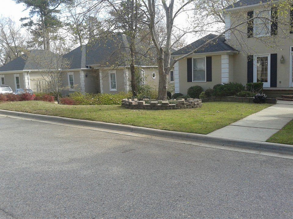 Suburban street with houses and manicured lawns. A car is parked in the distance.